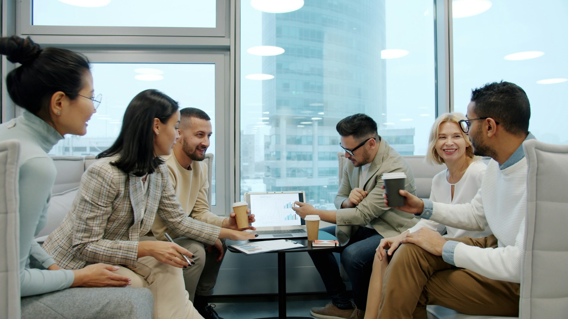 Corporate Training Diverse group of people in a modern office meeting.